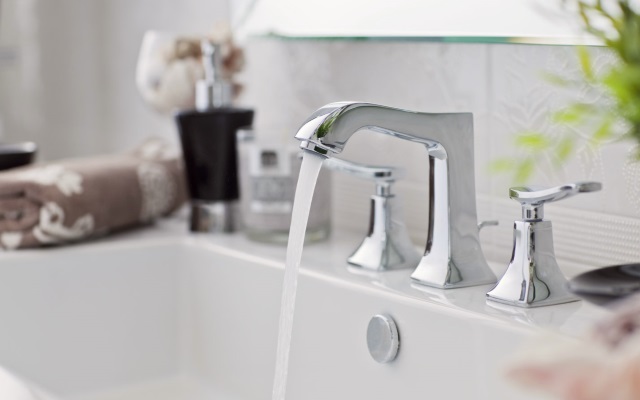 Beautiful bathroom sink with water coming out of faucet